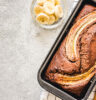 Cinnamon crunch banana bread on light concrete background.
