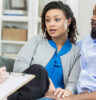 adult couple talk with female counselor about problems in their marriage.