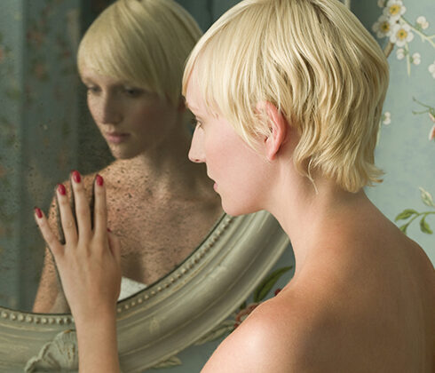 woman looking in the mirror