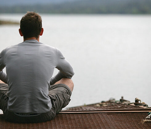 man looking across the water