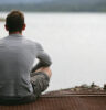 man looking across the water