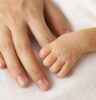 Baby hands and the hands of his mother.
