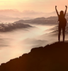 woman on a mountain watching sunset