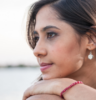 Woman resting chin on hands, gazing and thinking